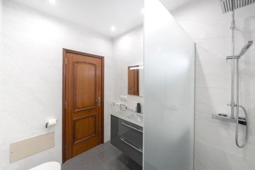 a bathroom with a shower and a toilet and a sink at Casa Coelho in Ponta do Sol
