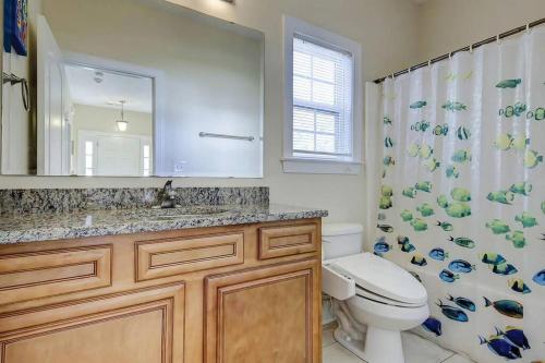 a bathroom with a toilet and a shower curtain at Spacious House with Pool near the Beach 2165 in Myrtle Beach