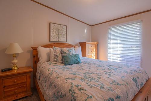 a bedroom with a large bed and a window at Stay In Ohiopyle near the GAP Trail - Ohiopyle, PA in Ohiopyle