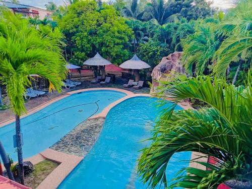 an image of a swimming pool at a resort at Coco Grove Nature Resort in Himensulan