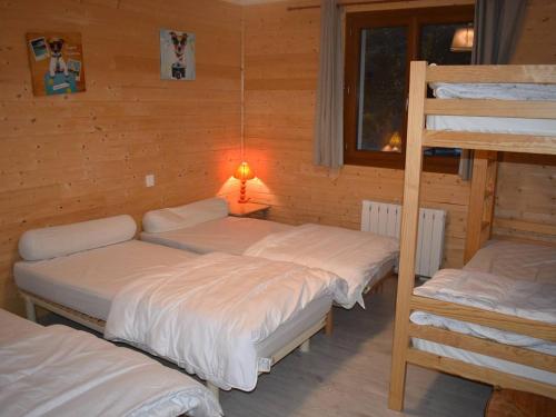 a room with three bunk beds and a lamp at Chalet Font-Romeu-Odeillo-Via, 6 pièces, 12 personnes - FR-1-580-103 in Font-Romeu-Odeillo-Via