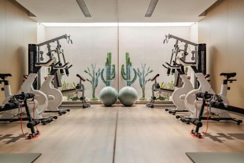 a gym with cardio machines and exercise bikes at The Skytel Hotel Shenzhen Central Park in Shenzhen