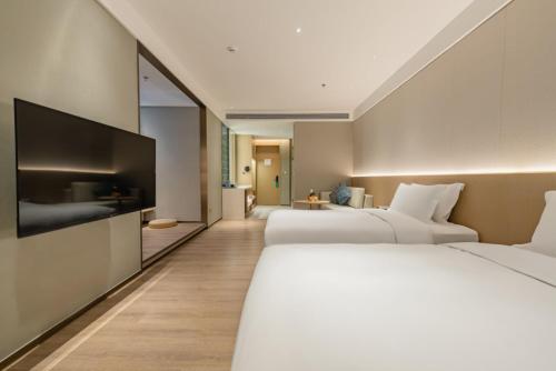 Säng eller sängar i ett rum på The Skytel Hotel Shenzhen Central Park