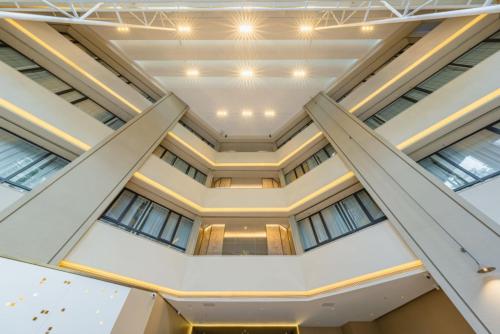 an open ceiling in a building with windows at The Skytel Hotel Shenzhen Central Park in Shenzhen