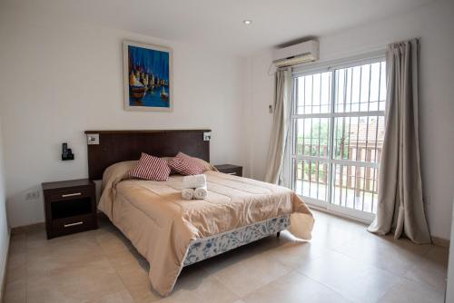 a bedroom with a bed and a large window at Apartamentos del mar II in Ostende