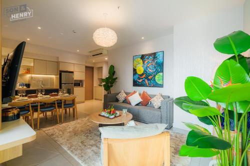 a living room with a couch and a table at Son&Henry Zenity District 1 in Ho Chi Minh City