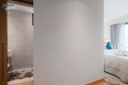 a bedroom with a bed and a window at Son&Henry Zenity District 1 in Ho Chi Minh City