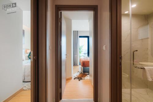 a bathroom with a walk in shower and a glass door at Son&Henry Zenity District 1 in Ho Chi Minh City