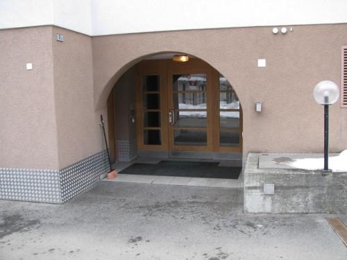 an entrance to a building with a wooden door at Landwasser in Davos