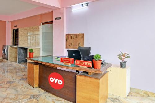 an office reception desk with a laptop on it at The Blue Pearl Hotel in Kolkata