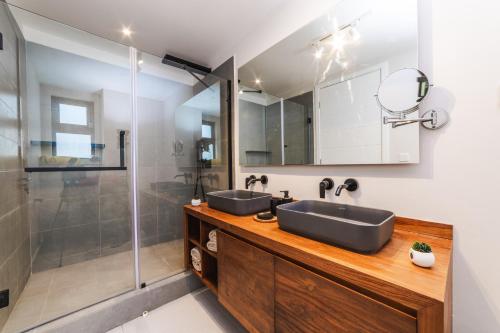 a bathroom with two sinks and a shower at Brand new, Beachfront Ocean Terraces, Poste Lafayette-Apt-C2 in Poste Lafayette