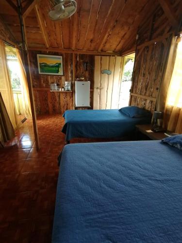 a bedroom with two beds in a room at Hotel Cotobruseño in San Francisco