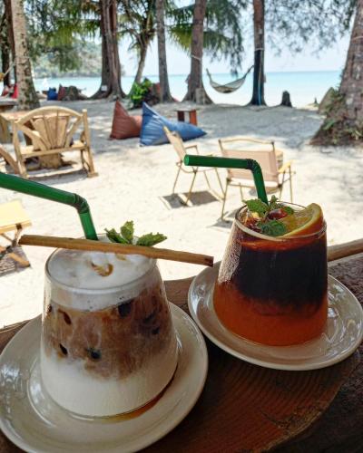 two bowls of food on plates on a table near the beach at Koh Kood Club in Ko Kood
