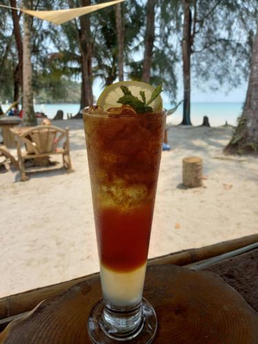 a drink sitting on top of a wooden table at Koh Kood Club in Ko Kood