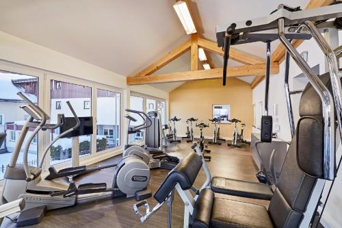 a gym with treadmills and elliptical machines at Dein Engel in Oberstaufen