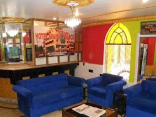 a living room with blue chairs and a bar at HOTEL STEP IN Bhubaneswar in Bhubaneshwar