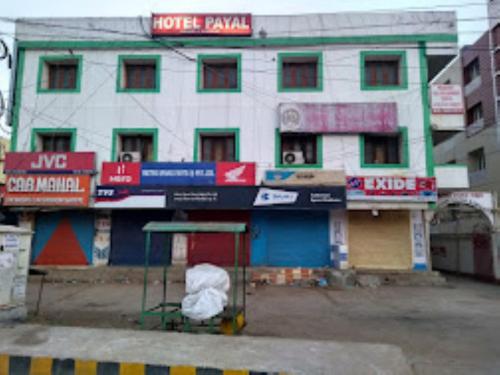 a building with colorful signs on the side of it at Hotel Payal Bhubaneswar in Bhubaneshwar