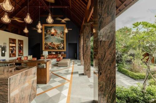a lobby of a house with a painting on the wall at La Reserve 1785 Canggu Beach - Adults Only in Canggu