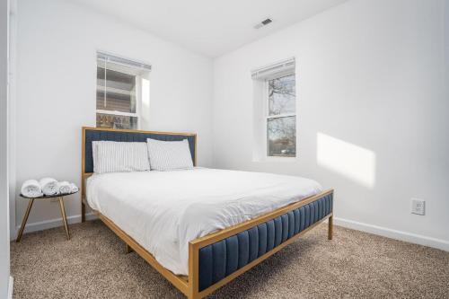 a white bedroom with a large bed in a room at Centrally Located 3BD Urban Oasis in Indianapolis