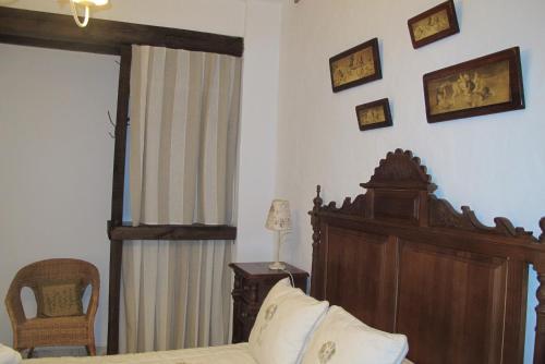 a bedroom with a bed and a chair at Casa Las Torres in Medina de las Torres