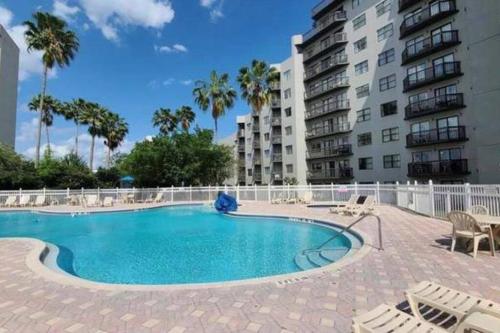 a swimming pool in front of a apartment building at Universal-Disney Dream 1211 Studio - The Enclave in Orlando