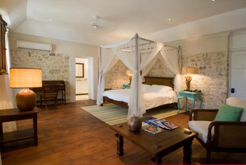 a bedroom with a bed with a canopy at The Atlantis Historic Inn in Saint Joseph