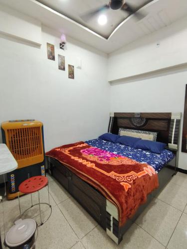 een slaapkamer met een bed, een tafel en een stoel bij Swastik Yatri Grah in Ujjain
