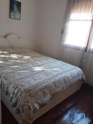 ein Schlafzimmer mit einem Bett mit einer Decke darauf in der Unterkunft Hana Private Home in Pogradec