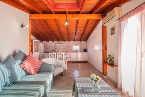 a living room with a couch and a table at Sunset rooftop apartment in Thessaloniki