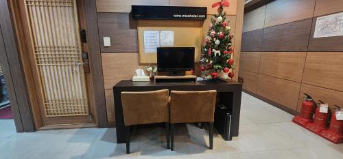 a desk with a computer and a christmas tree at Mizo Hotel in Seoul