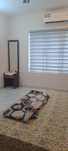 a rug on the floor in a room with a window at 1 bhk luxury flat in Trivandrum