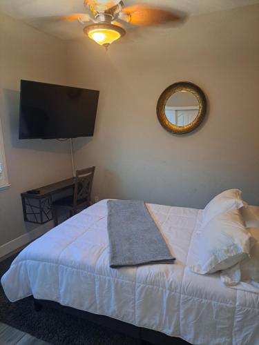 1 dormitorio con 1 cama con ventilador de techo y espejo en In Law Unit, 2 bedroom Suite, en Roseville