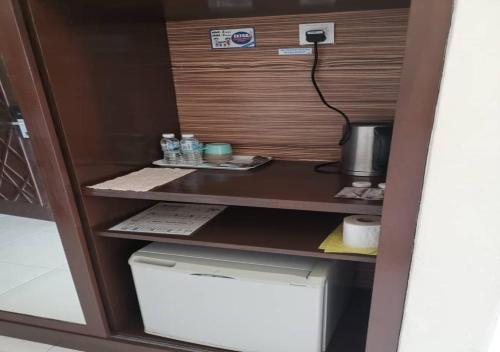 a cupboard with a desk and a printer in a room at Gold Coast Morib Rerost By Sweetime in Kampong Tanjong Pechah