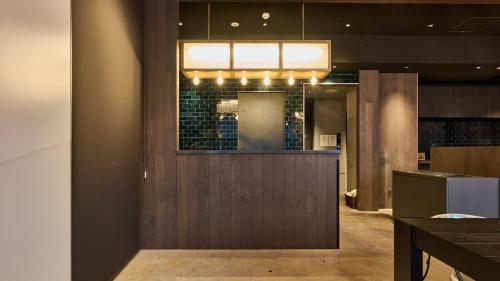 a lobby with a counter and a window in a building at Hotel Plus Hostel TOKYO AKIHABARA in Tokyo