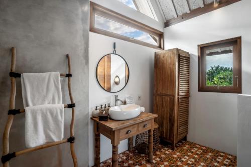 a bathroom with a sink and a mirror at Villa Loma by Alfred in Bali in Seminyak