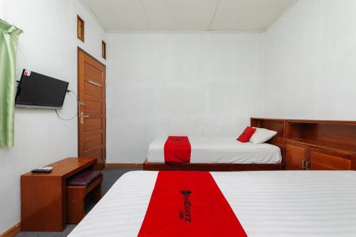 Cama o camas de una habitación en RedDoorz Syariah @ Panglima Nyak Makam Aceh 2