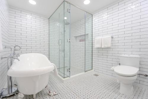 a bathroom with a toilet and a sink and a shower at Arabian Boutique Hotel in Dubai