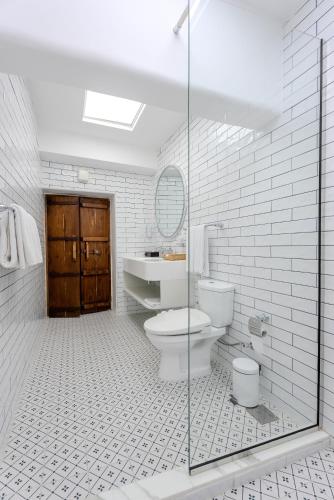 a bathroom with a toilet and a sink and a mirror at Arabian Boutique Hotel in Dubai