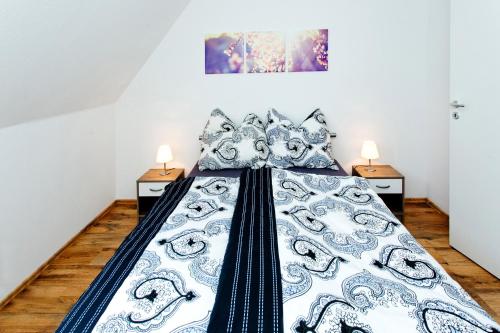 a bed in a room with two night stands at NEU! Ferienwohnung zum Wiesenblick in Toppenstedt