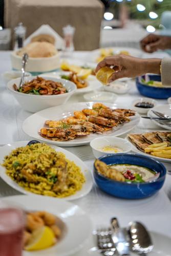 a table with plates of food on it at Arabian Boutique Hotel in Dubai
