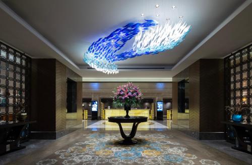 a lobby with a vase of flowers on a table at Windsor Hotel & Convention Center Istanbul in Istanbul