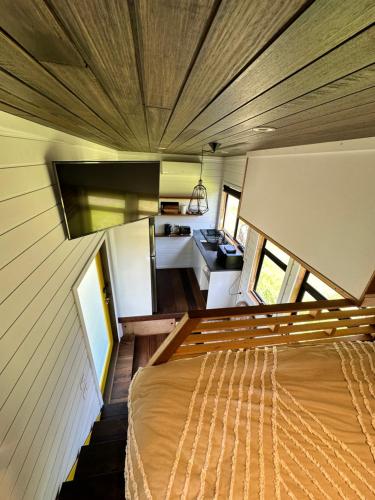 a room with a bed in a tiny house at Ocean Breeze Tiny House - Ocean and Lake View in Mallacoota