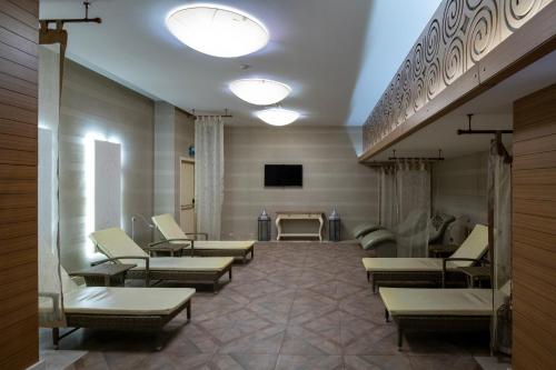 a waiting room with couches and a tv at Windsor Hotel & Convention Center Istanbul in Istanbul