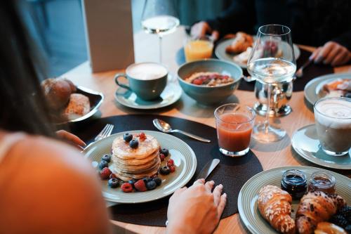 a table with pancakes and other breakfast foods on it at Hotel Sun Valley in Selva di Val Gardena