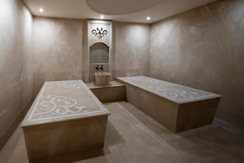 a large bathroom with a tub and a sink at Windsor Hotel & Convention Center Istanbul in Istanbul