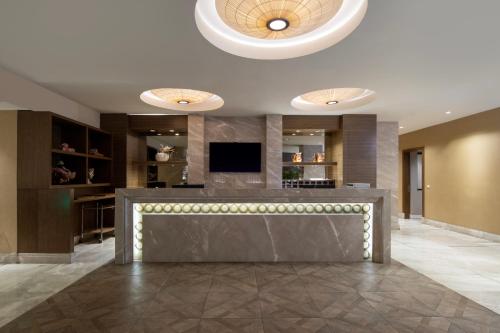 a lobby with a bar with a television in it at Windsor Hotel & Convention Center Istanbul in Istanbul