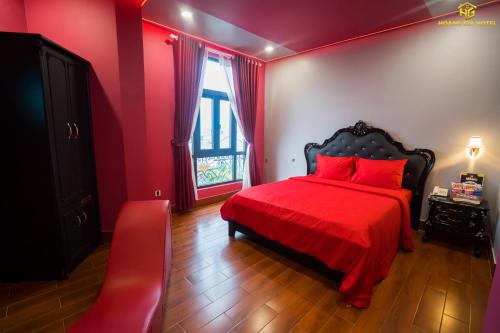 a red bedroom with a red bed and a window at Hoàng Gia Hotel Tuy Hoà in Tuy Hoa