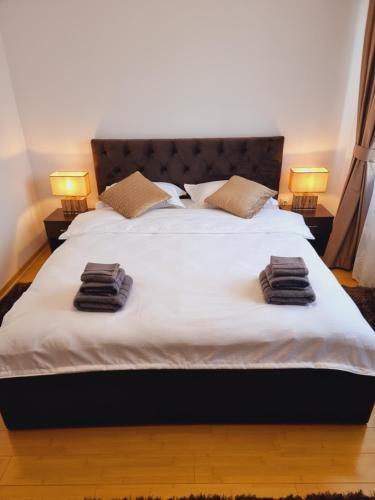 a large white bed with two pillows on it at Apartament Ultracentral Suceava in Suceava