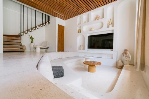 a living room with a white couch and a table at Unity Villas Canggu in Canggu