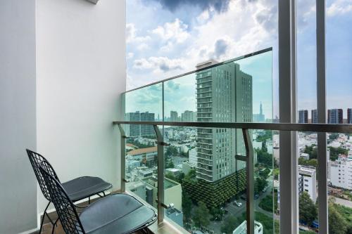 a balcony with a chair and a view of a city at DingD0ng Home FelizEnVista 5-star facilities in Ho Chi Minh City